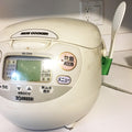 a white rice cooker sitting on top of a counter