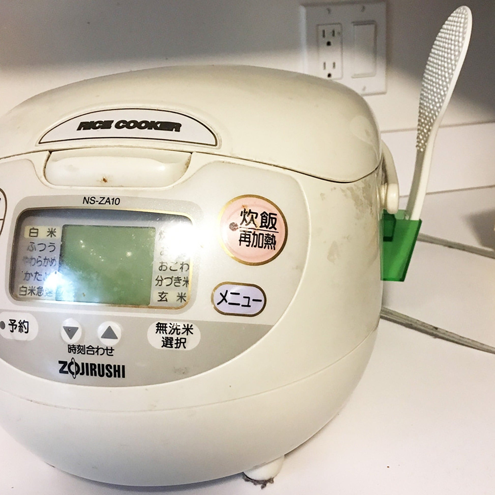 a white rice cooker sitting on top of a counter