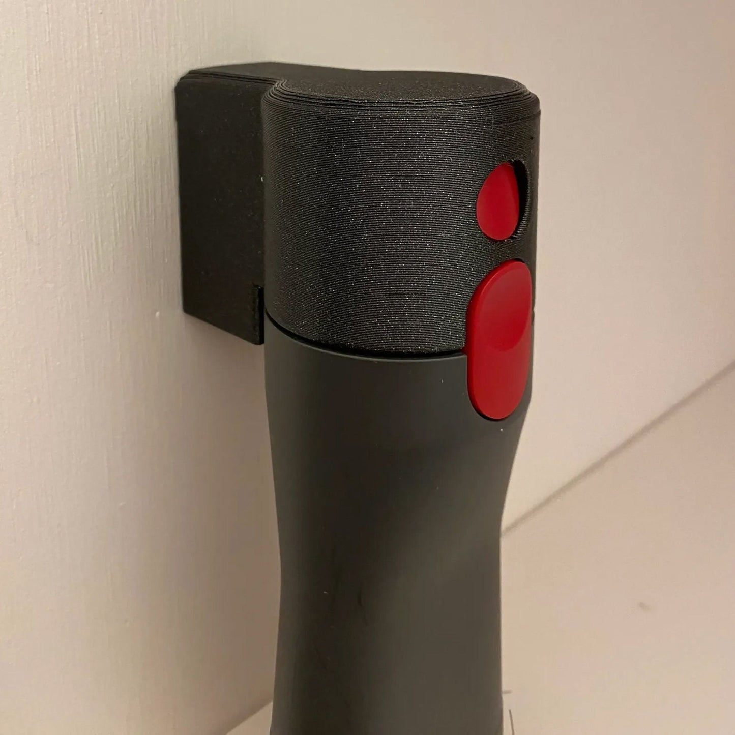 a close up of a black and red object on a wall