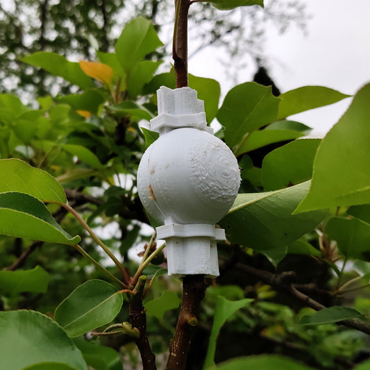 a white fire hydrant sitting on top of a tree