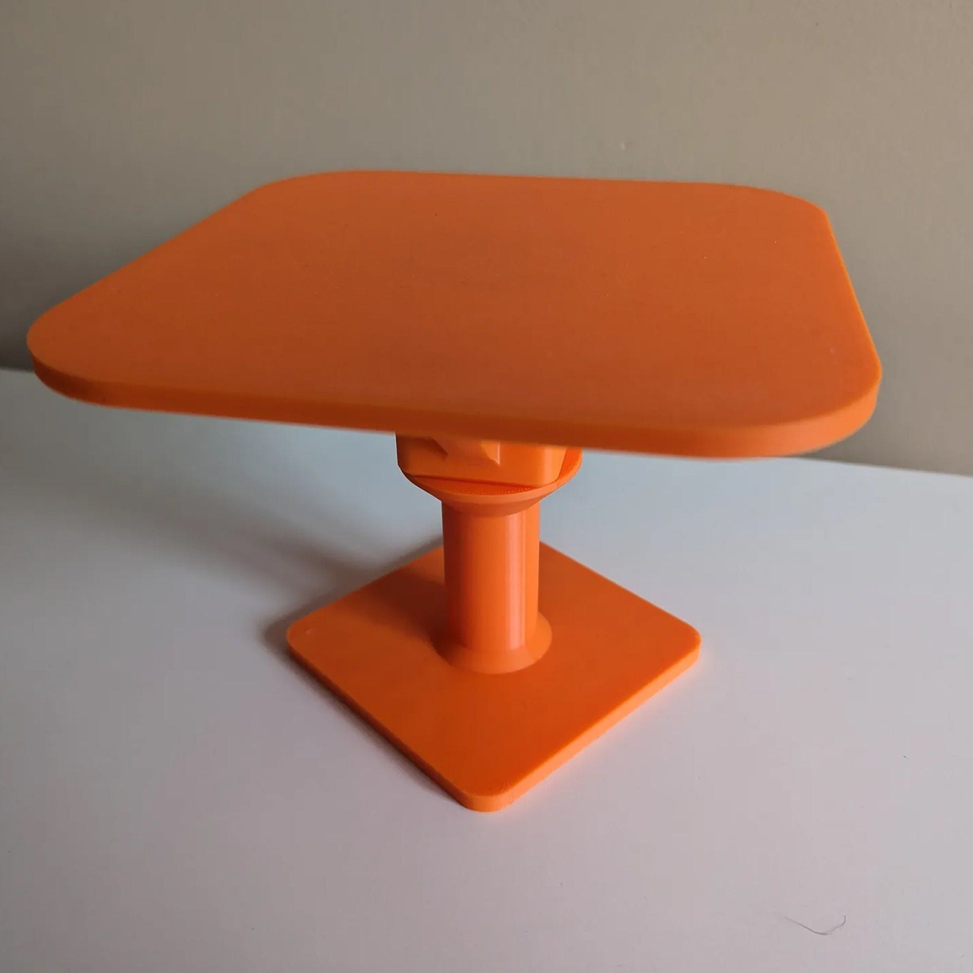 an orange table top on a white surface