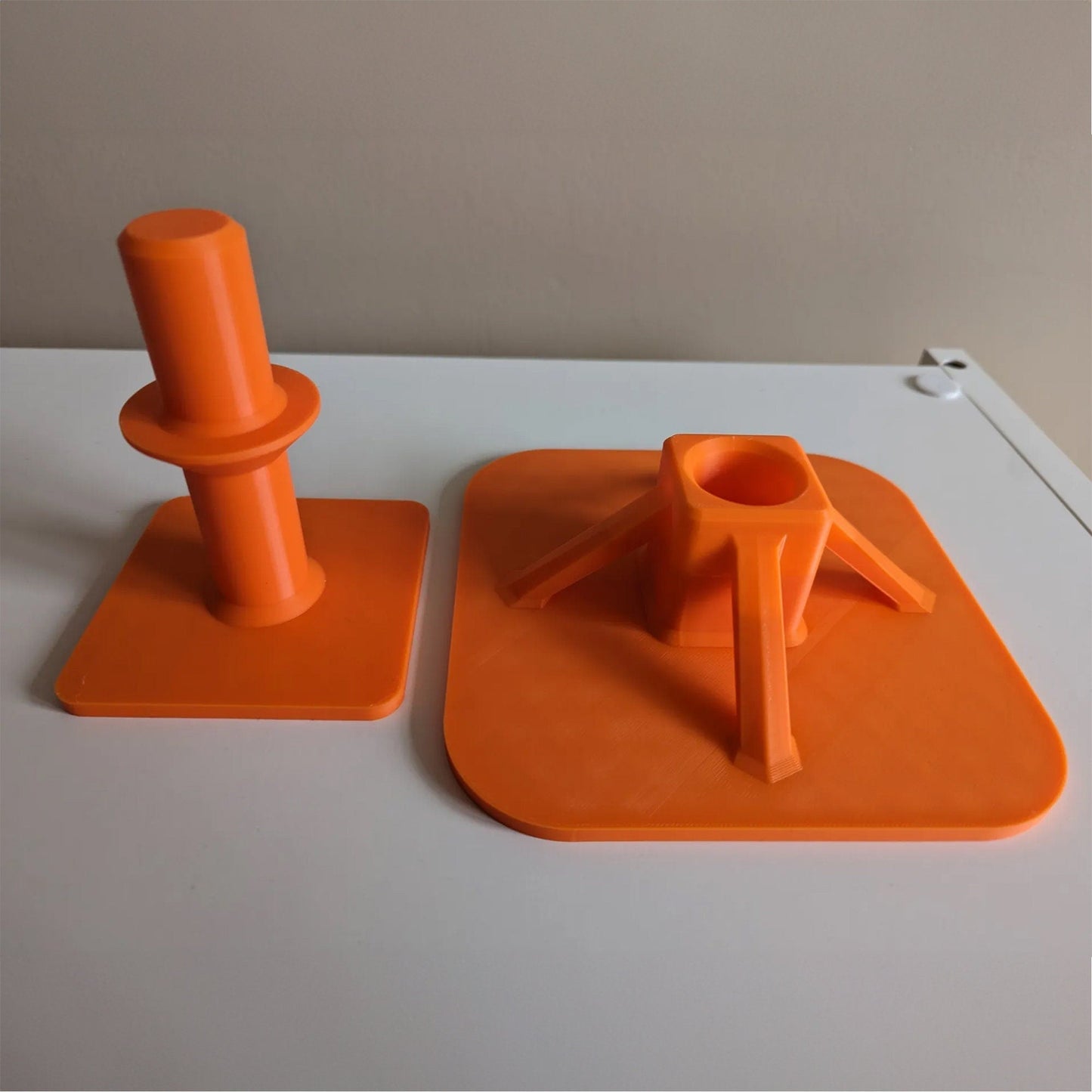 a couple of orange objects sitting on top of a white table