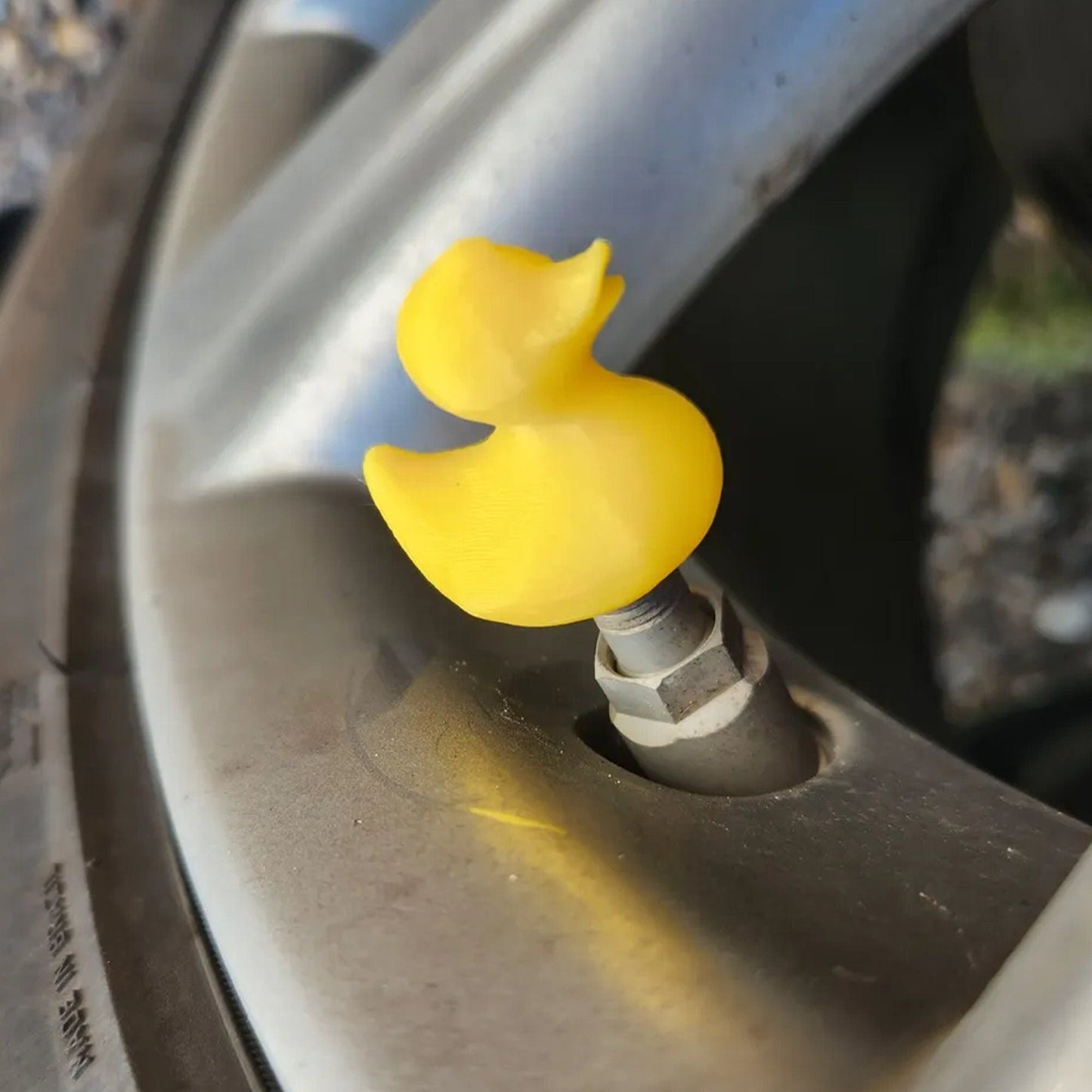 a close up of a tire with a yellow knob