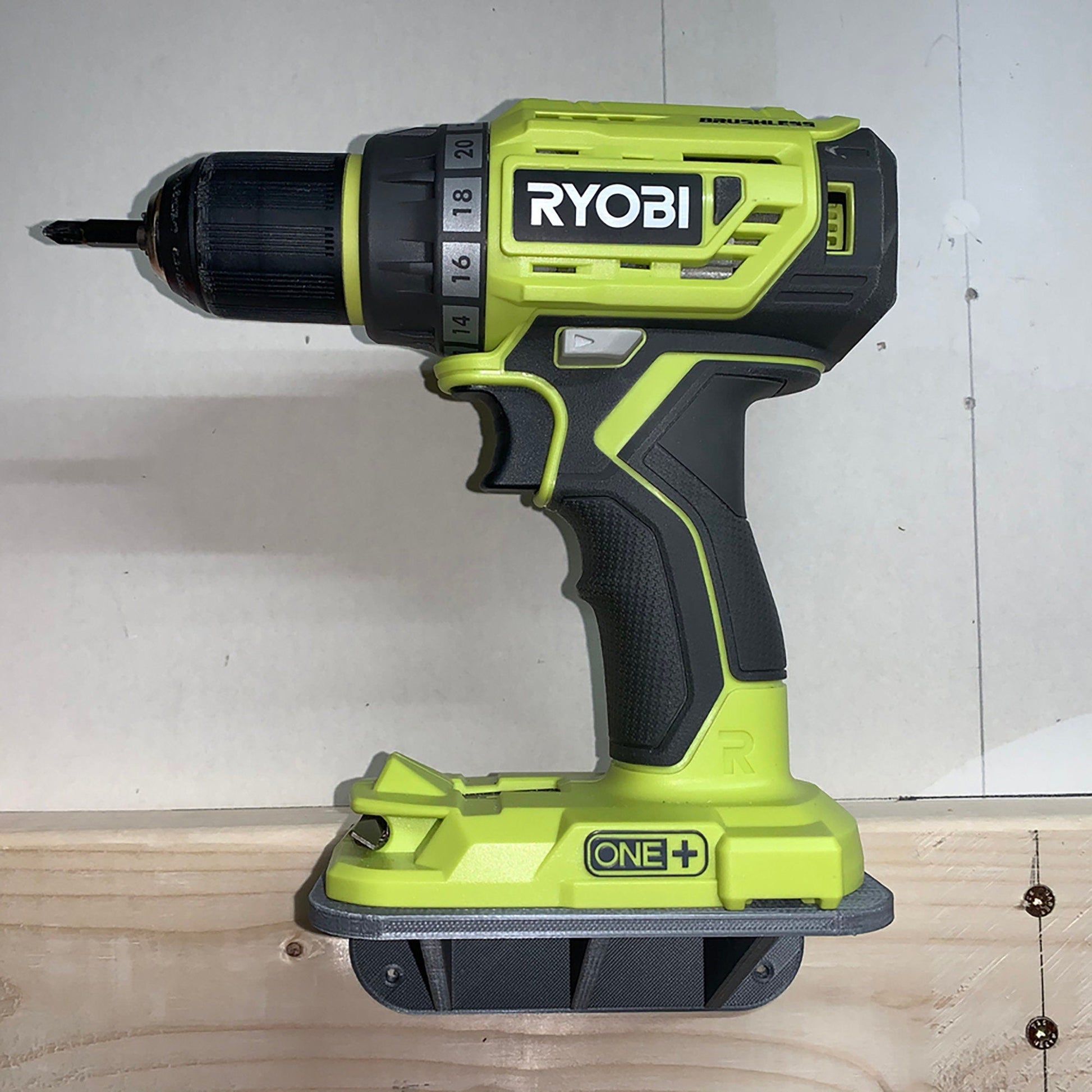 a cordless drill is sitting on a piece of wood