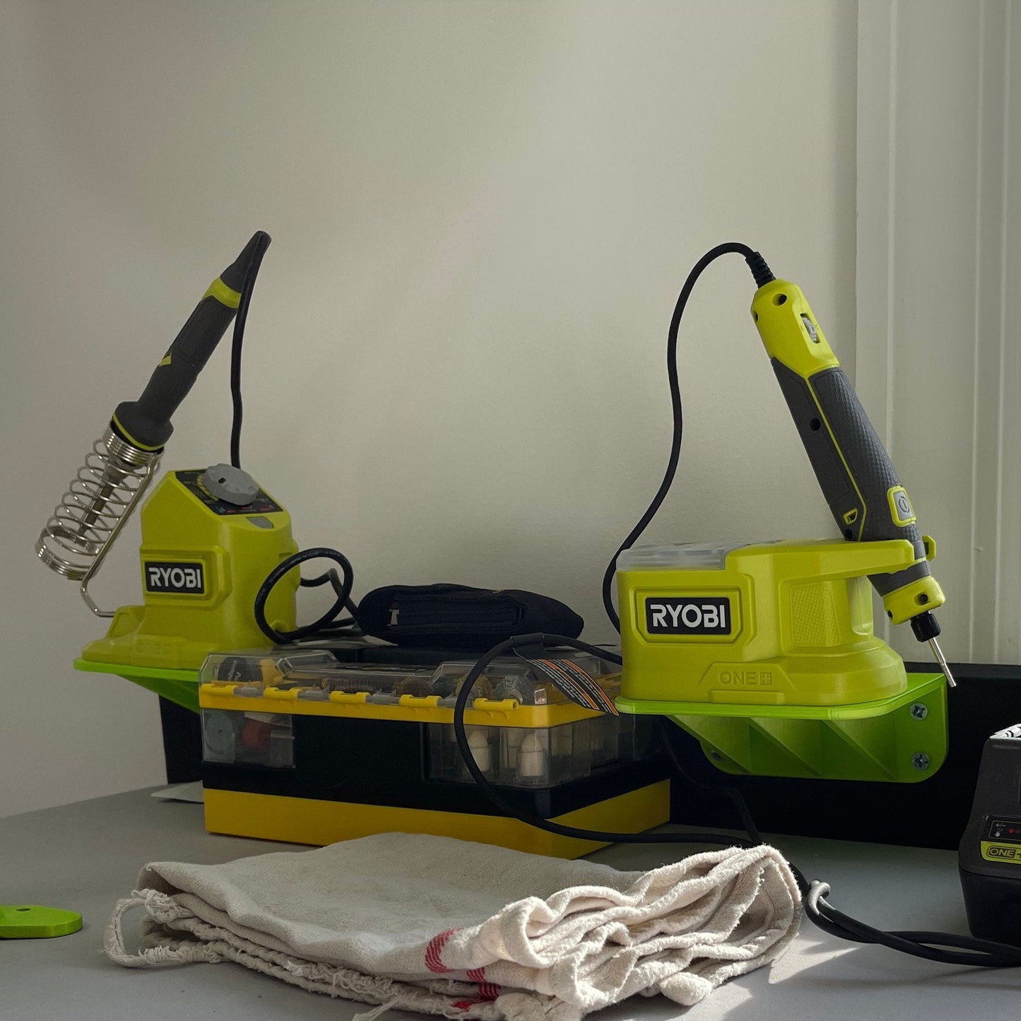 a couple of green and yellow vacuums sitting on top of a table