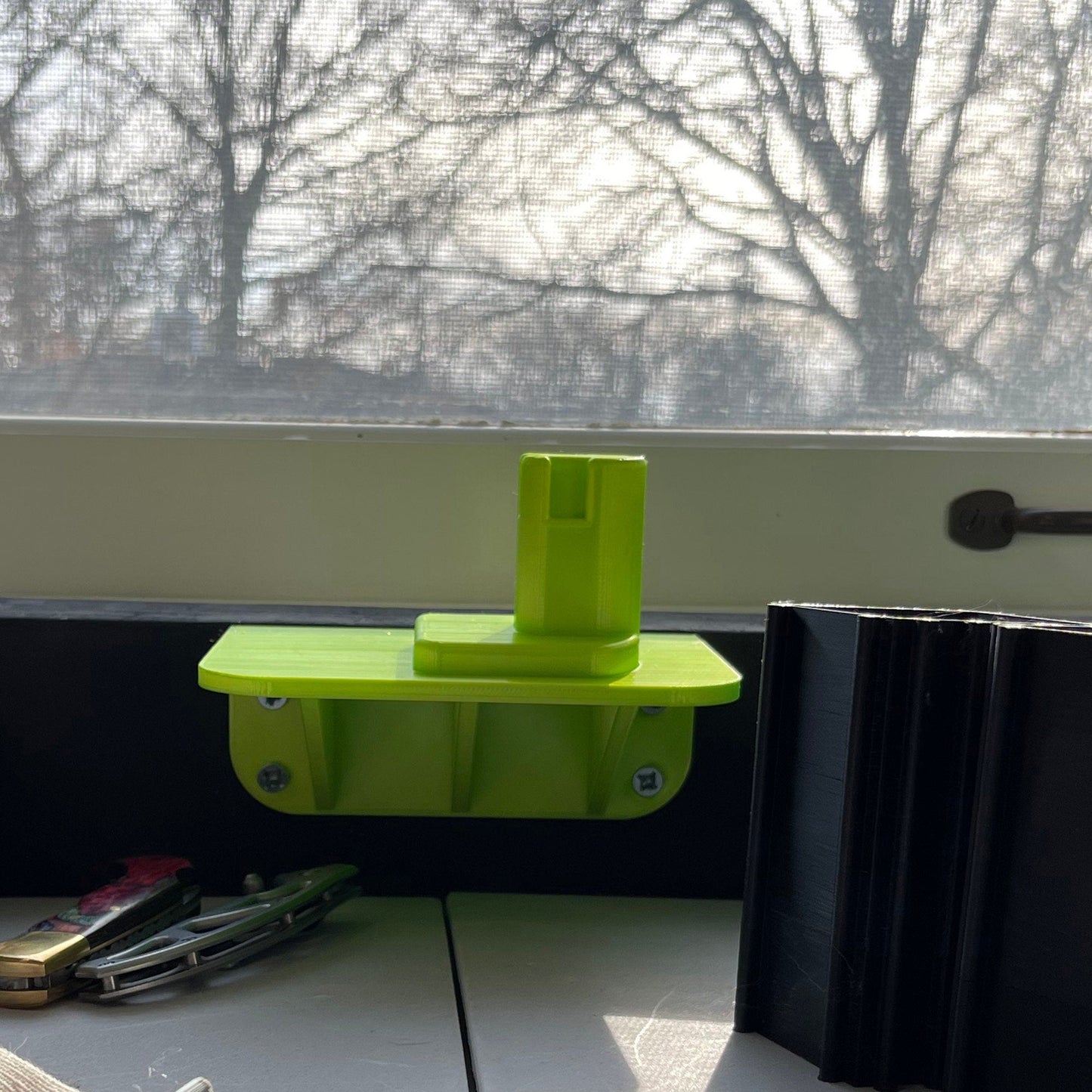 a green shelf sitting on top of a counter next to a window