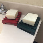 Self-draining slatted soap dish on the edge of a kitchen sink