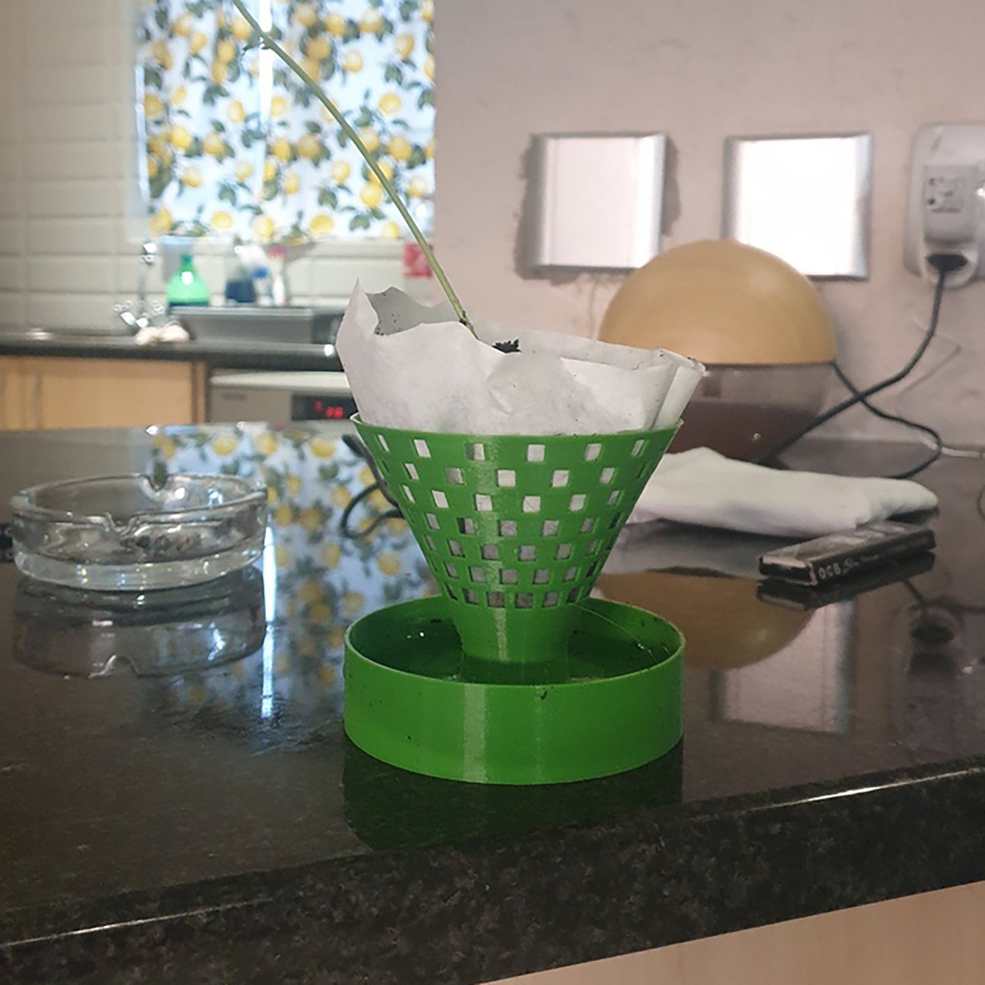 a kitchen counter with a green basket on top of it