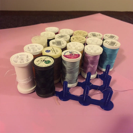 a group of spools of thread sitting on top of a table