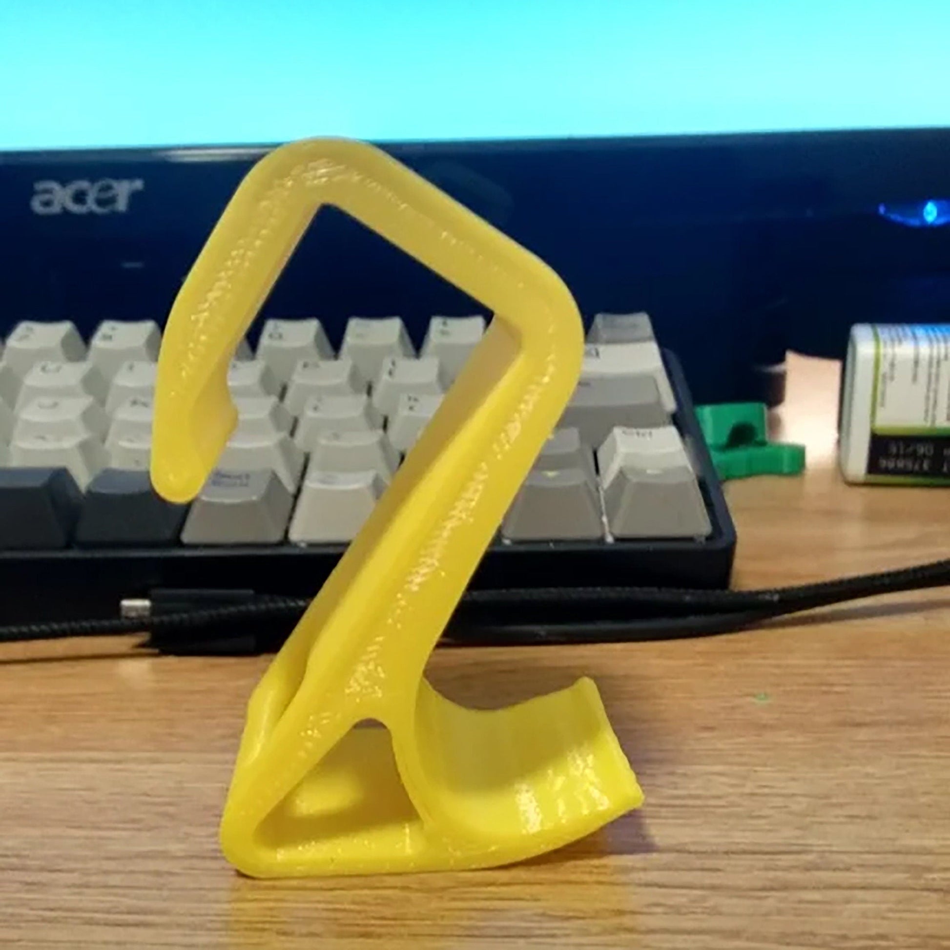 a computer keyboard sitting on top of a wooden desk