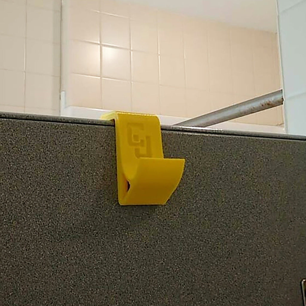 Over-the-door shower hook hanging a towel on a glass shower door