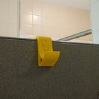 Over-the-door shower hook hanging a towel on a glass shower door