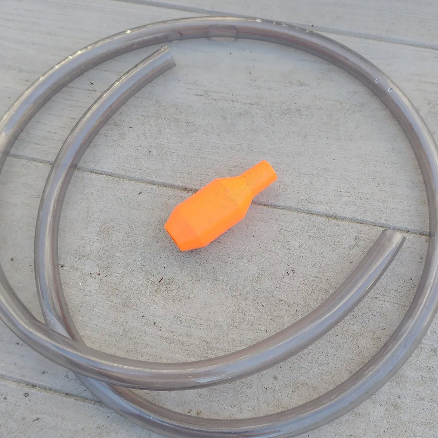 an orange object sitting on top of a cement floor