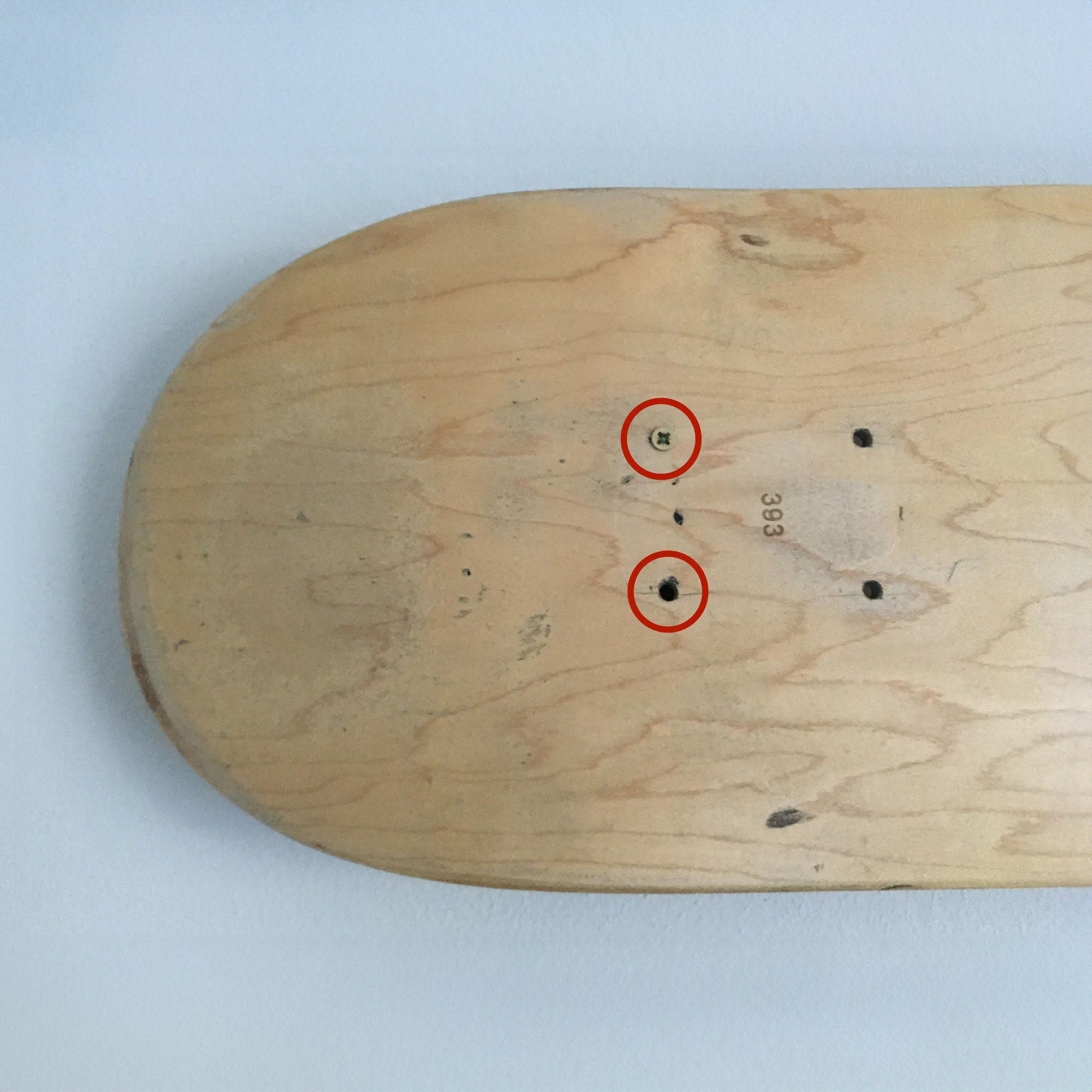 a wooden board with three red circles on it