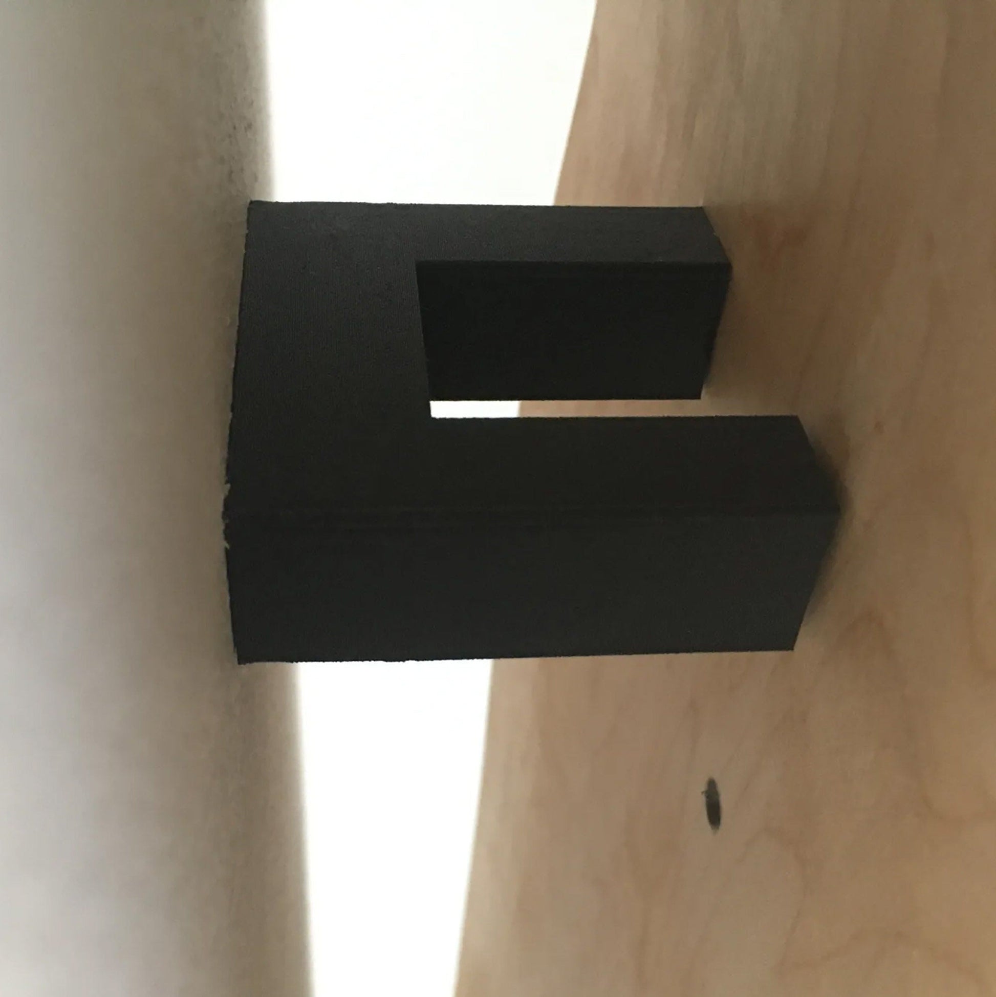 a close up of a black object on a wall