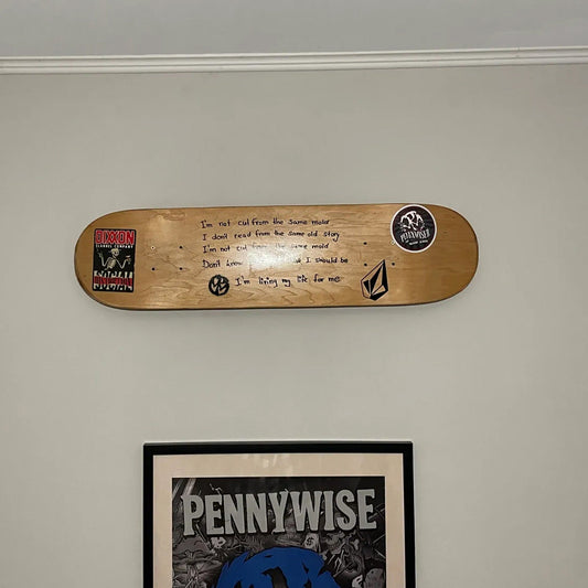 a wooden skateboard mounted to the side of a wall