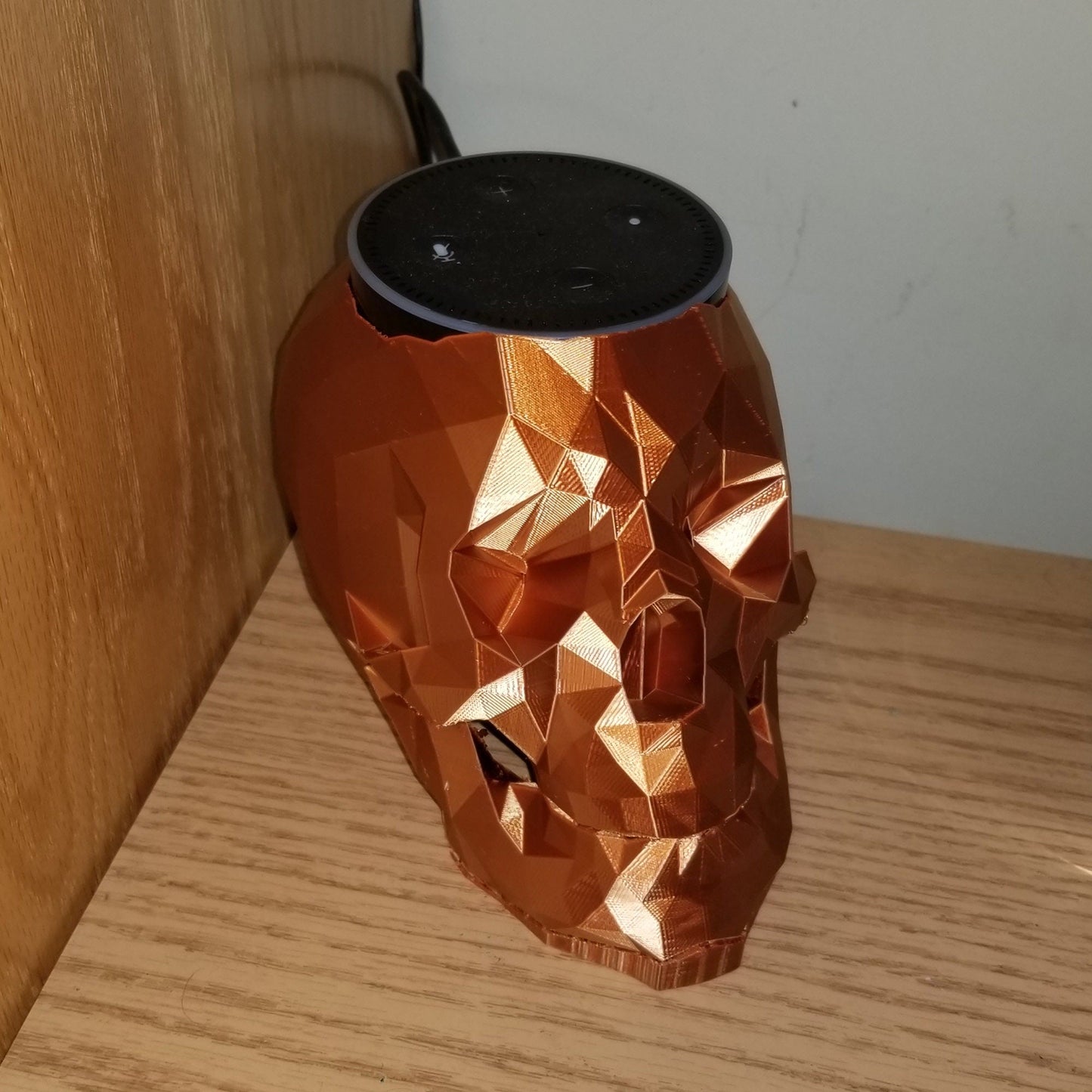 a speaker sitting on top of a wooden table