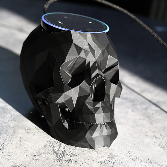 a black skull shaped speaker sitting on top of a table