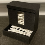 Covered cotton swab dispenser with a front catch tray on a bathroom vanity, view 2