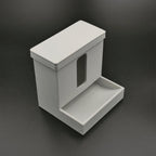 Covered cotton swab dispenser with a front catch tray on a bathroom vanity, view 3