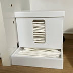 Covered cotton swab dispenser with a front catch tray on a bathroom vanity, view 5