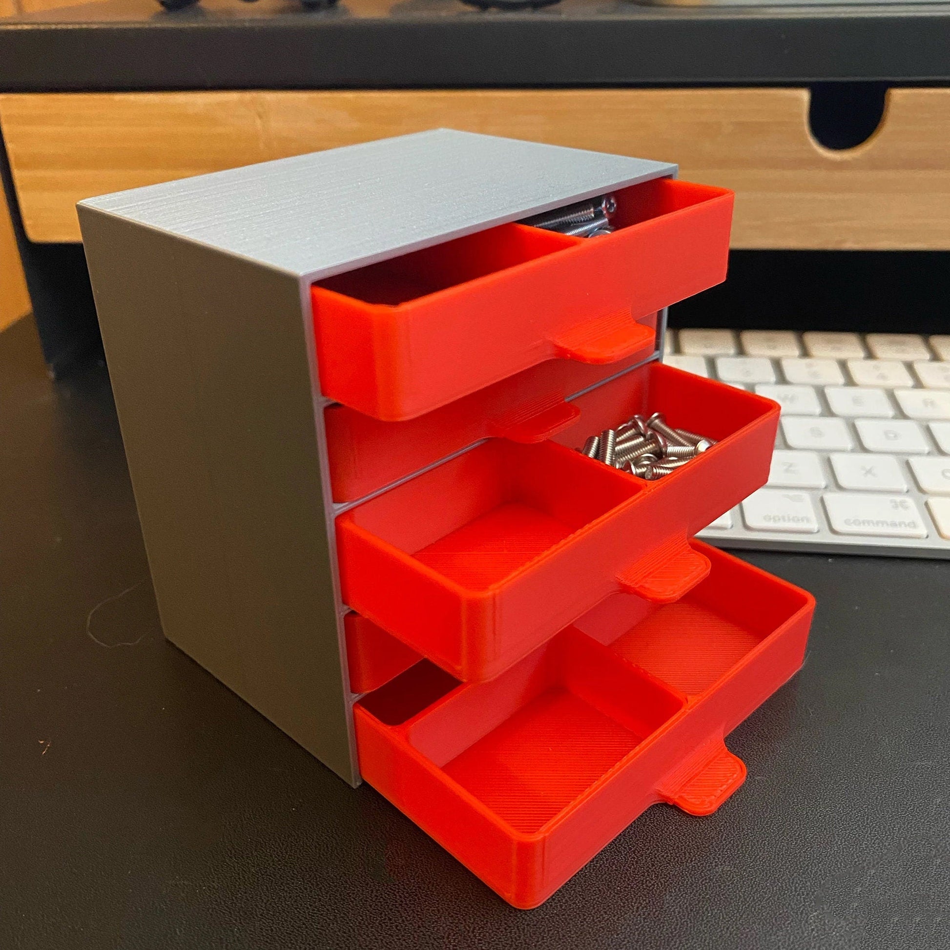 a desk with a keyboard and a red drawer