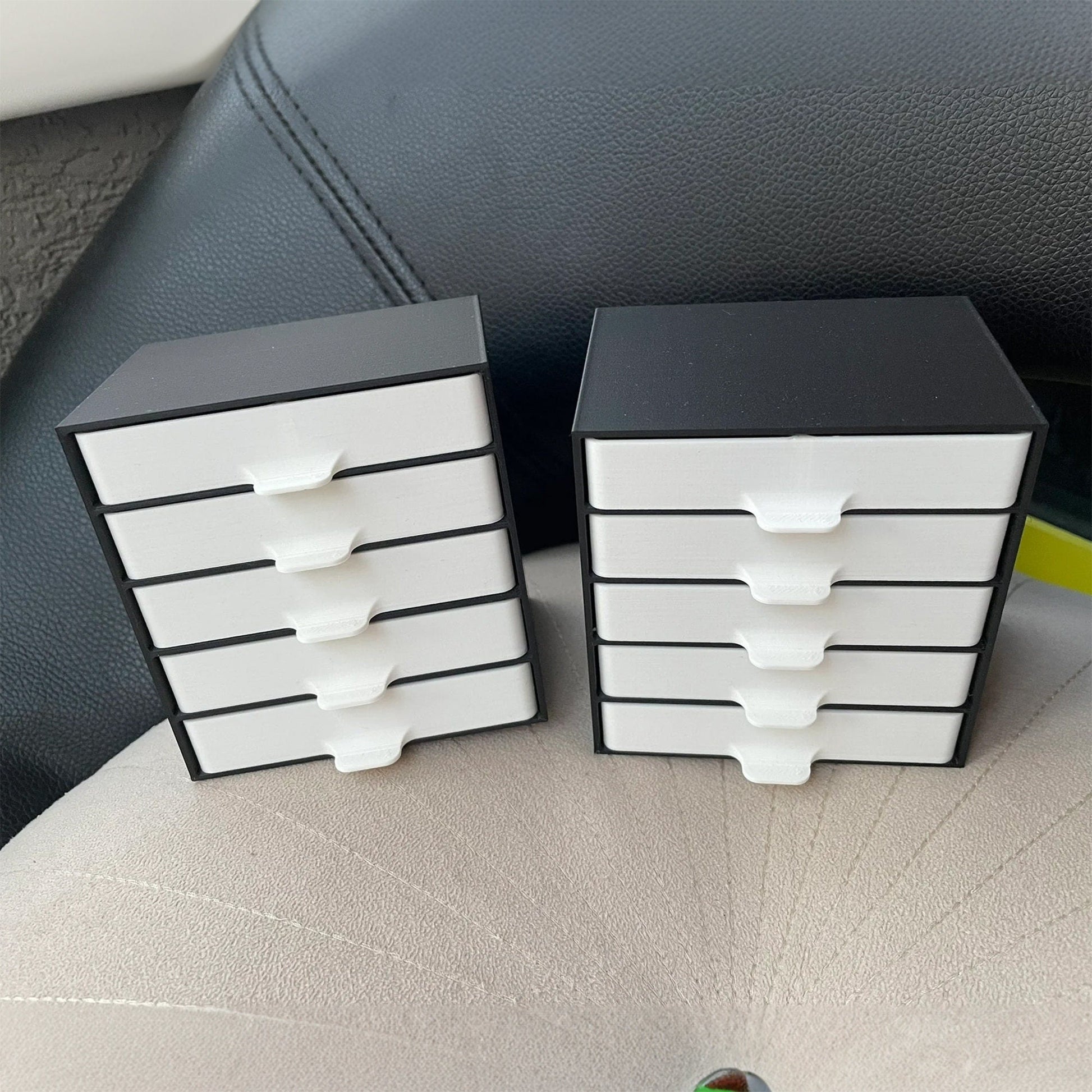 a close up of two small drawers on a car seat