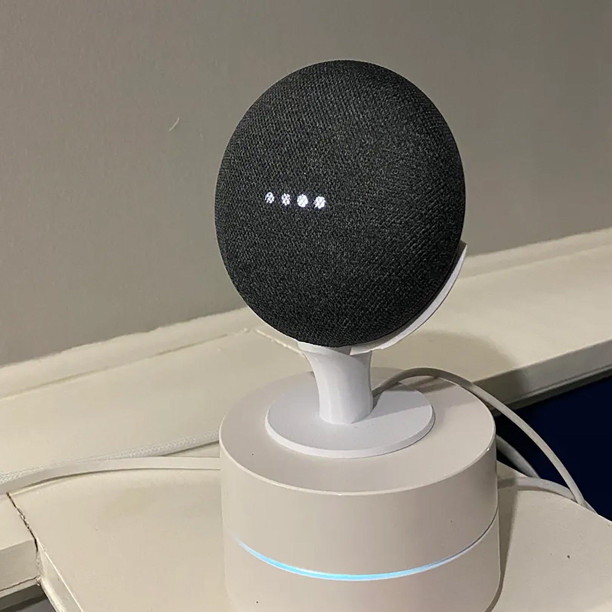 a white speaker sitting on top of a table