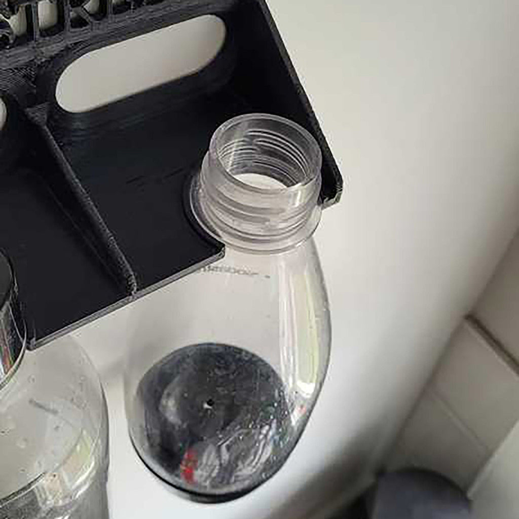 Wall-mounted drying rack holding two SodaStream Jet bottles upside down, view 2