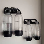 Wall-mounted drying rack holding two SodaStream Jet bottles upside down