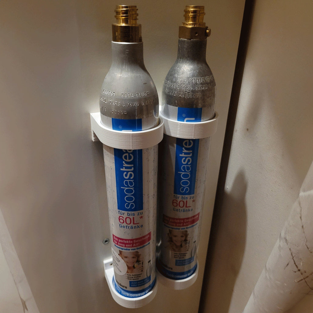 Wall mount rack holding spare SodaStream 60L CO2 cylinders under a cabinet, view 4