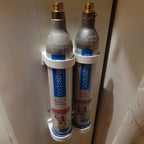 Wall mount rack holding spare SodaStream 60L CO2 cylinders under a cabinet, view 4