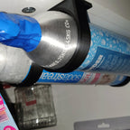 Wall mount rack holding spare SodaStream 60L CO2 cylinders under a cabinet, view 5