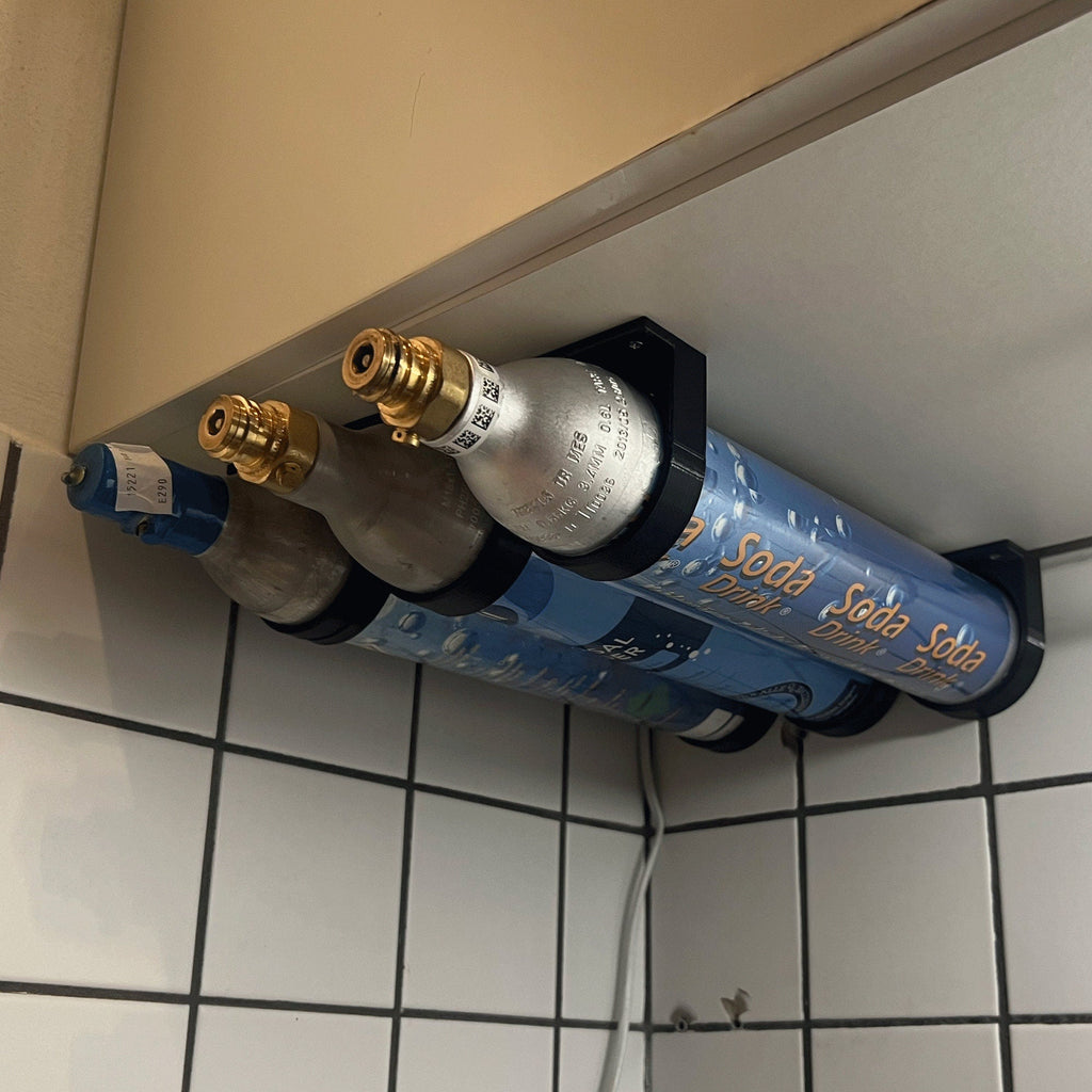 Wall mount rack holding spare SodaStream 60L CO2 cylinders under a cabinet