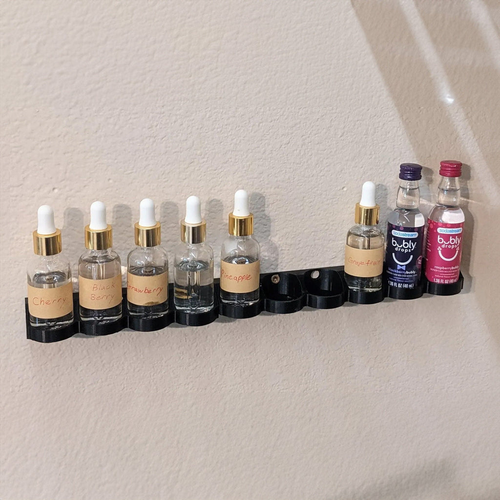 Wall rack holding 40ml SodaStream flavor bottles in a row, view 2