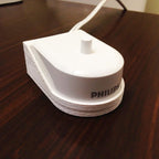 Wall mount holder for a Sonicare HX6100 charger with toothbrush docked, view 4