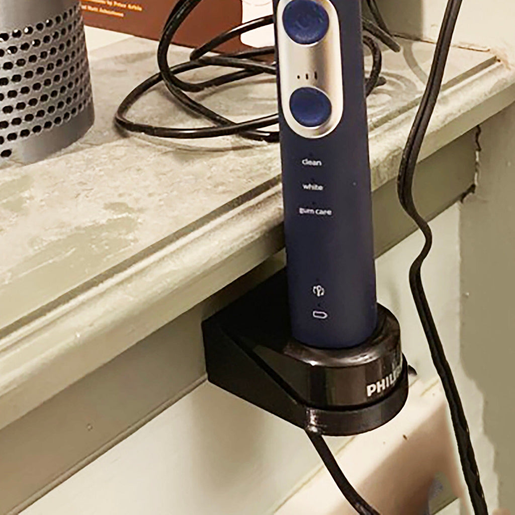 Wall mount holder for a Sonicare HX6100 charger with toothbrush docked, view 6