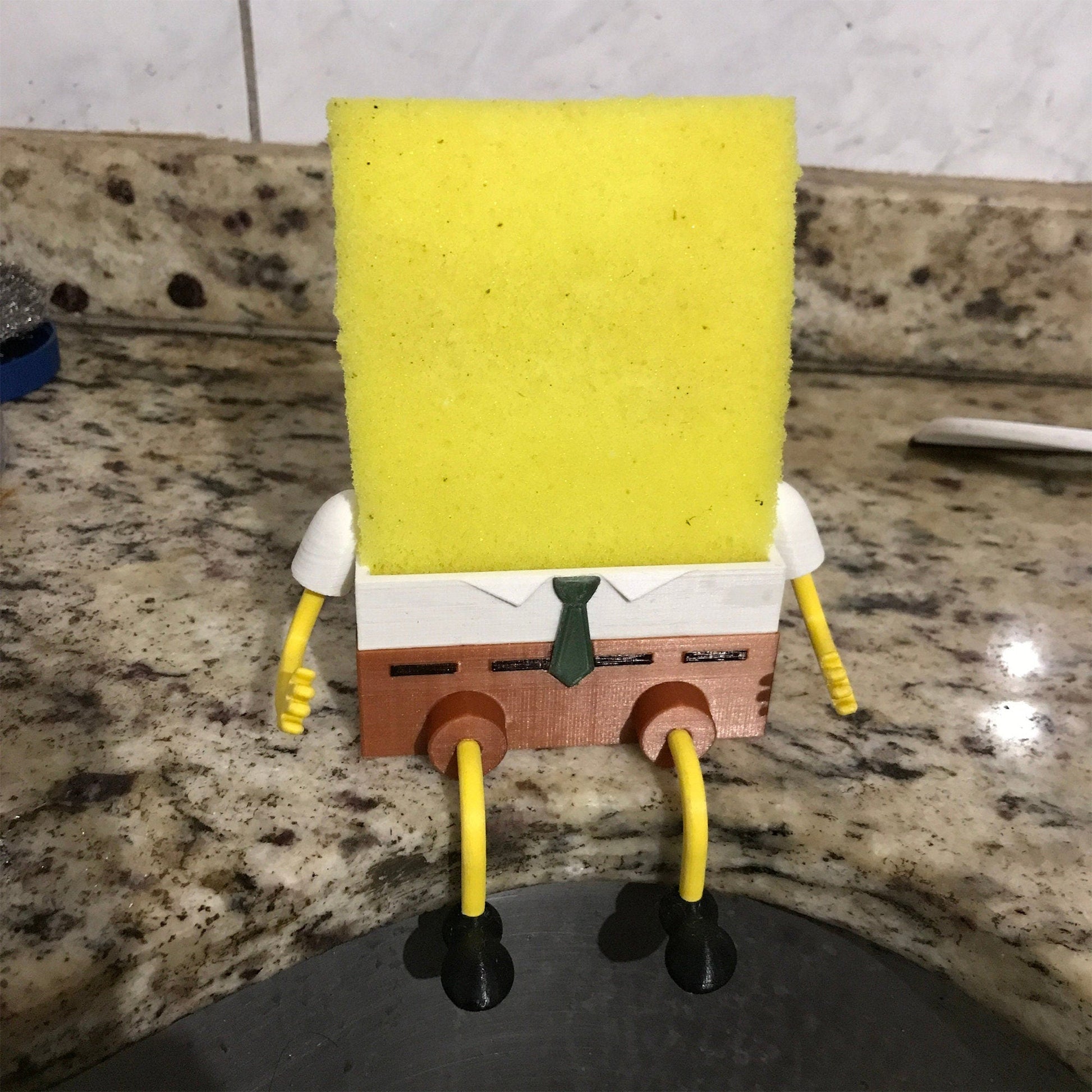 a spongebob figure sitting on top of a sink