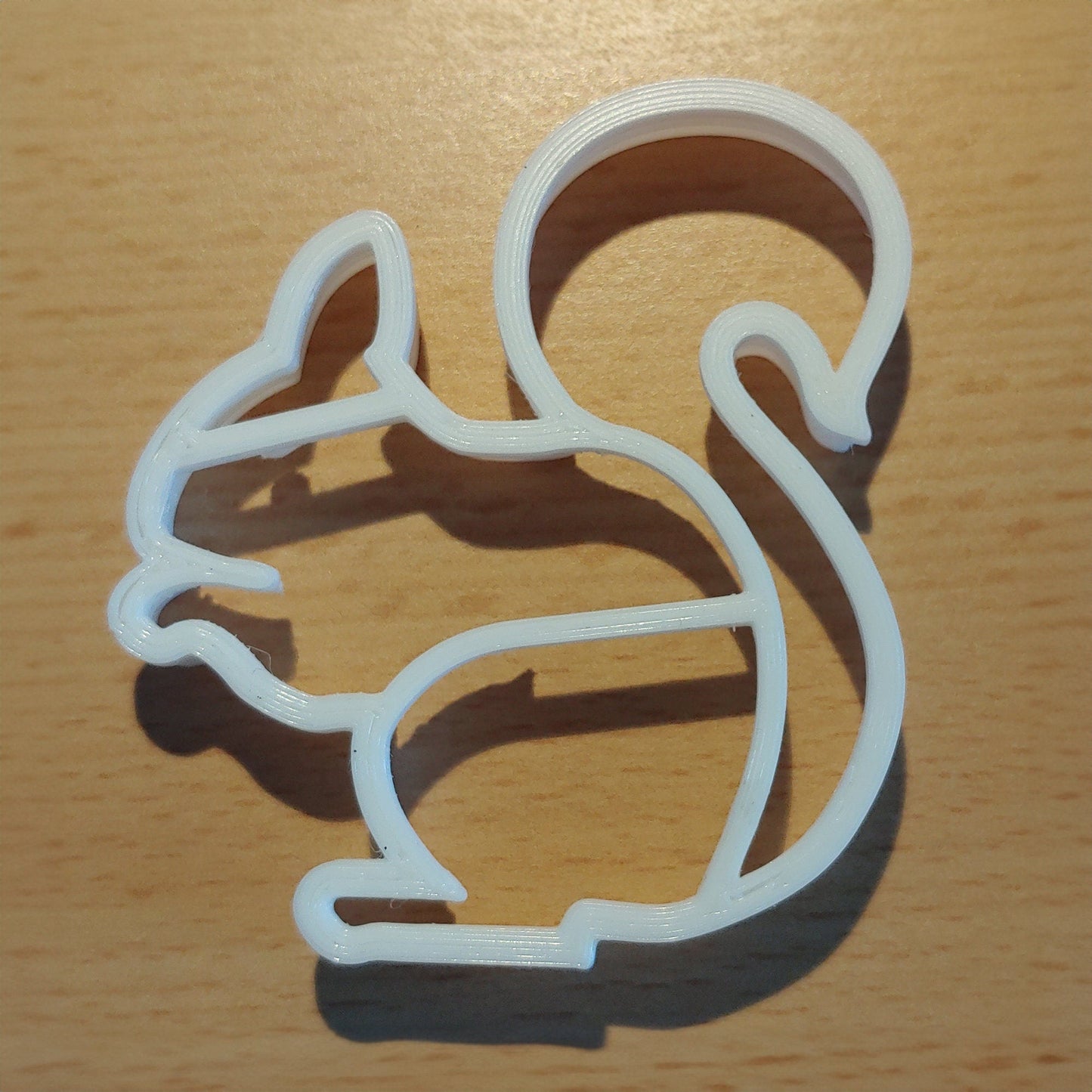 a cookie cutter shaped like a cat on a table