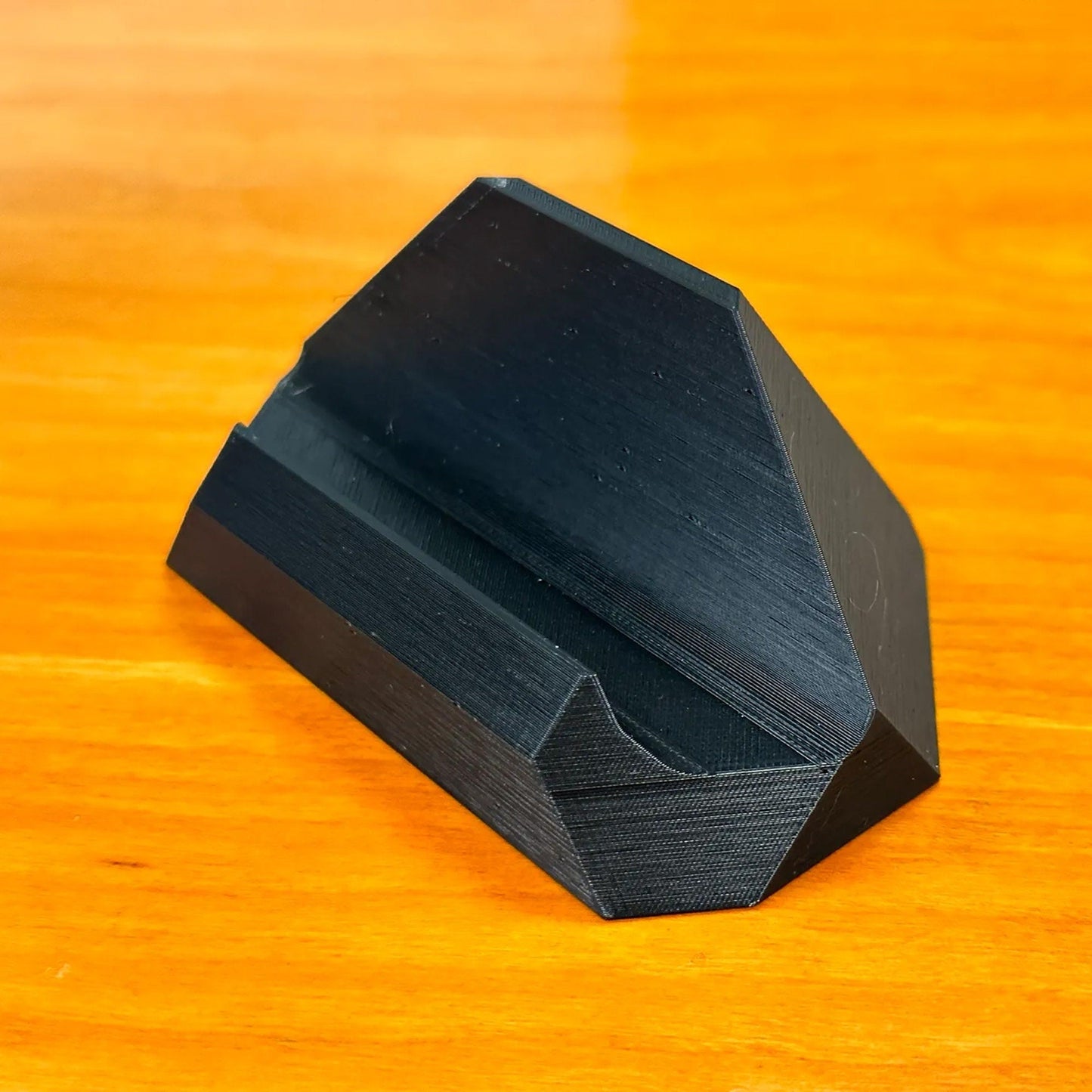 a black object sitting on top of a wooden table