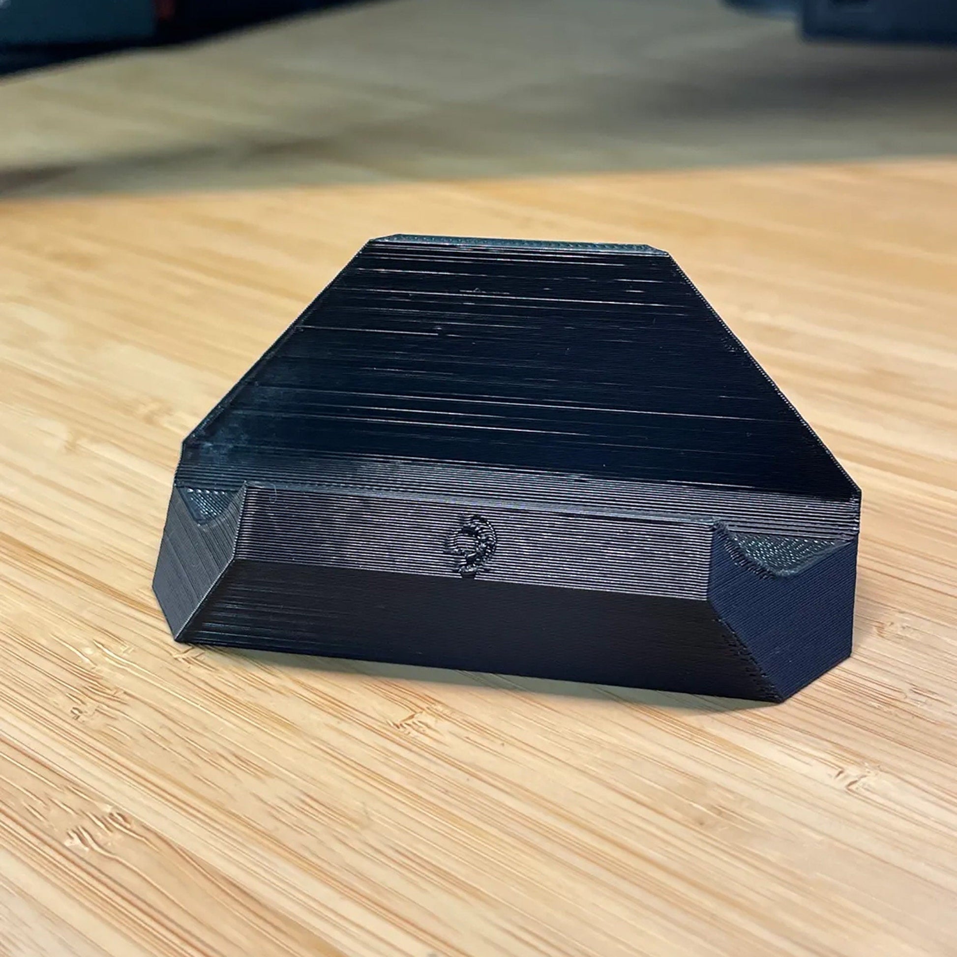 a black box sitting on top of a wooden table