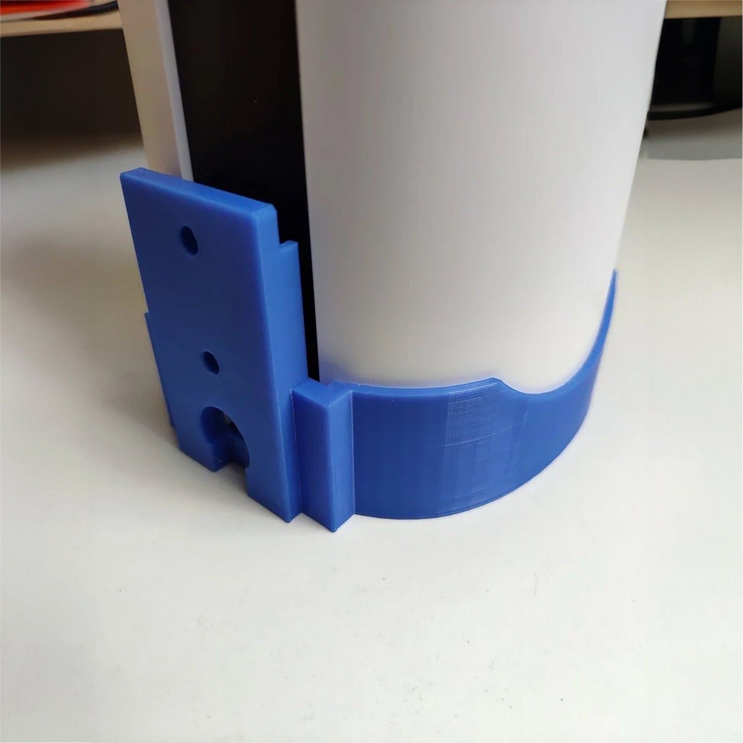 a plastic cup with a blue handle on a table