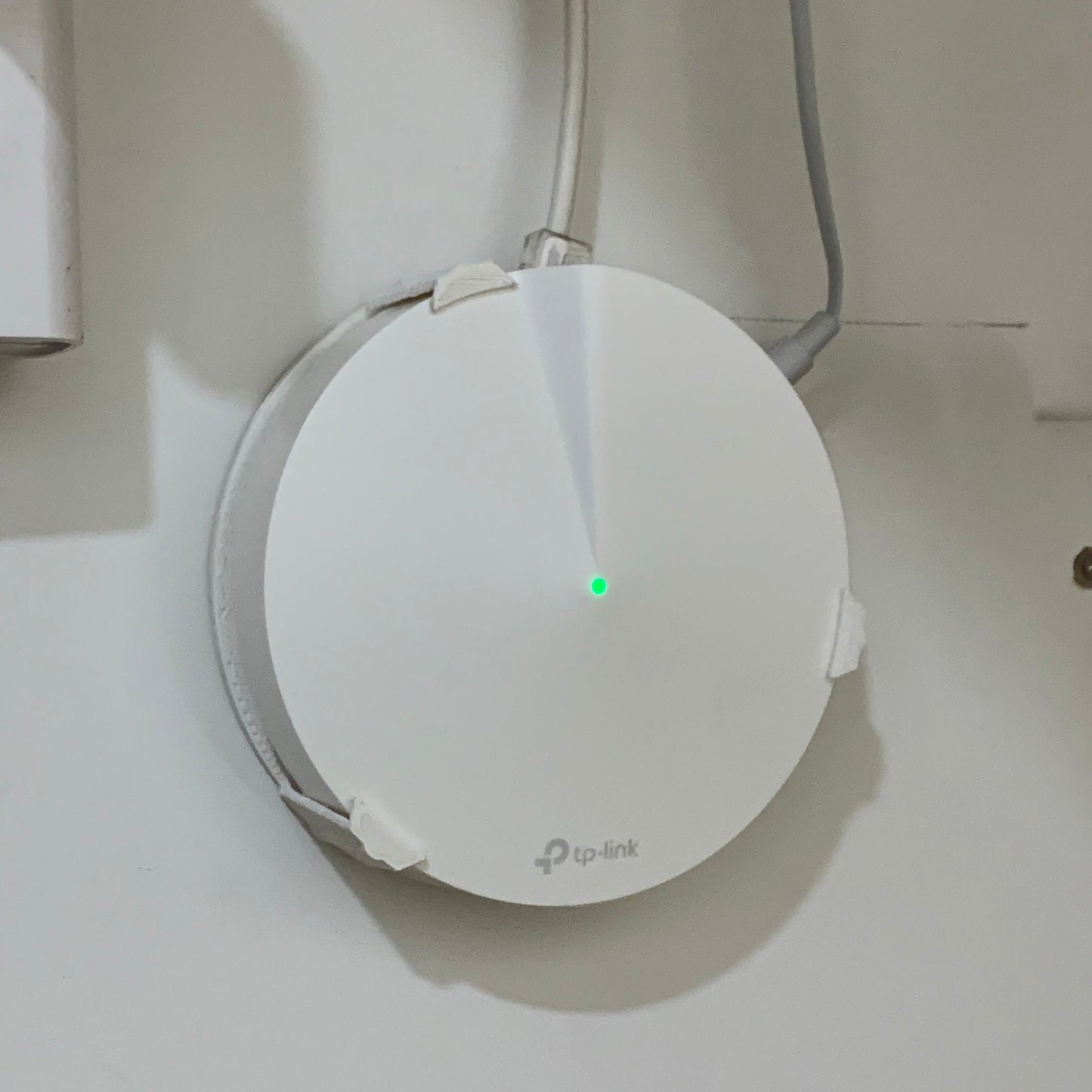 a white device with a green light on it