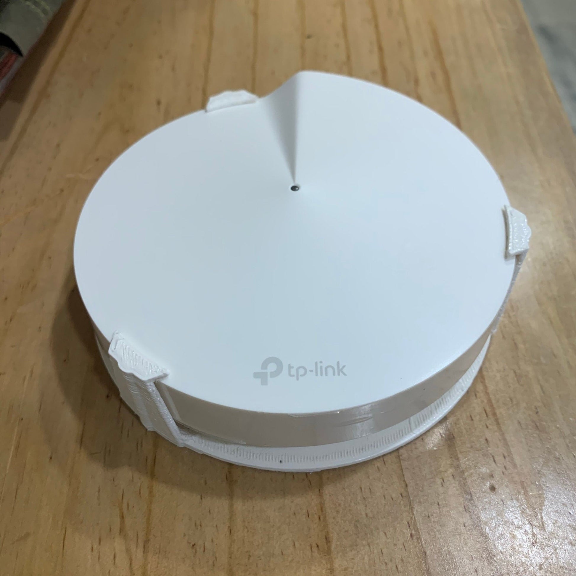 a white object sitting on top of a wooden table