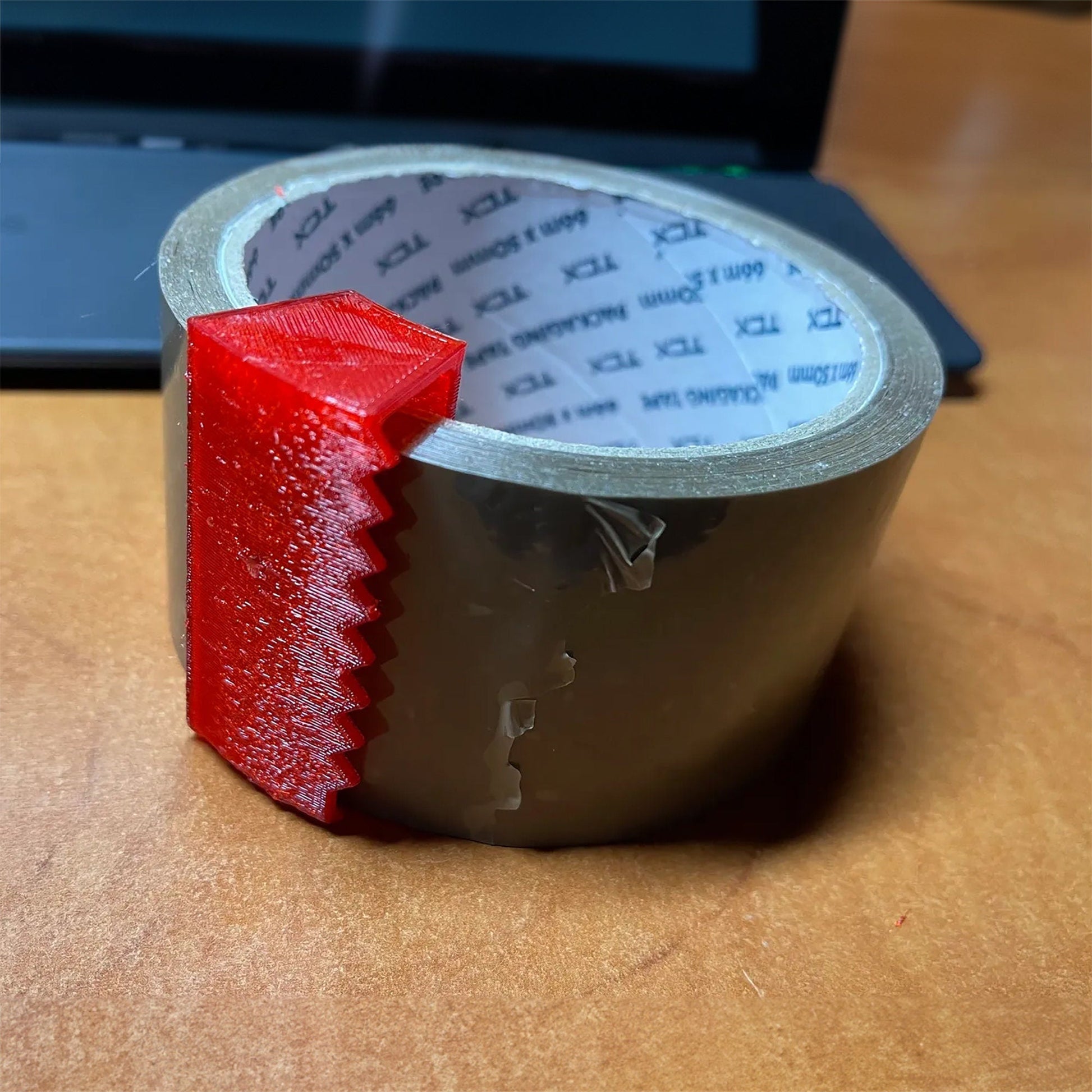 a roll of tape sitting on top of a wooden table