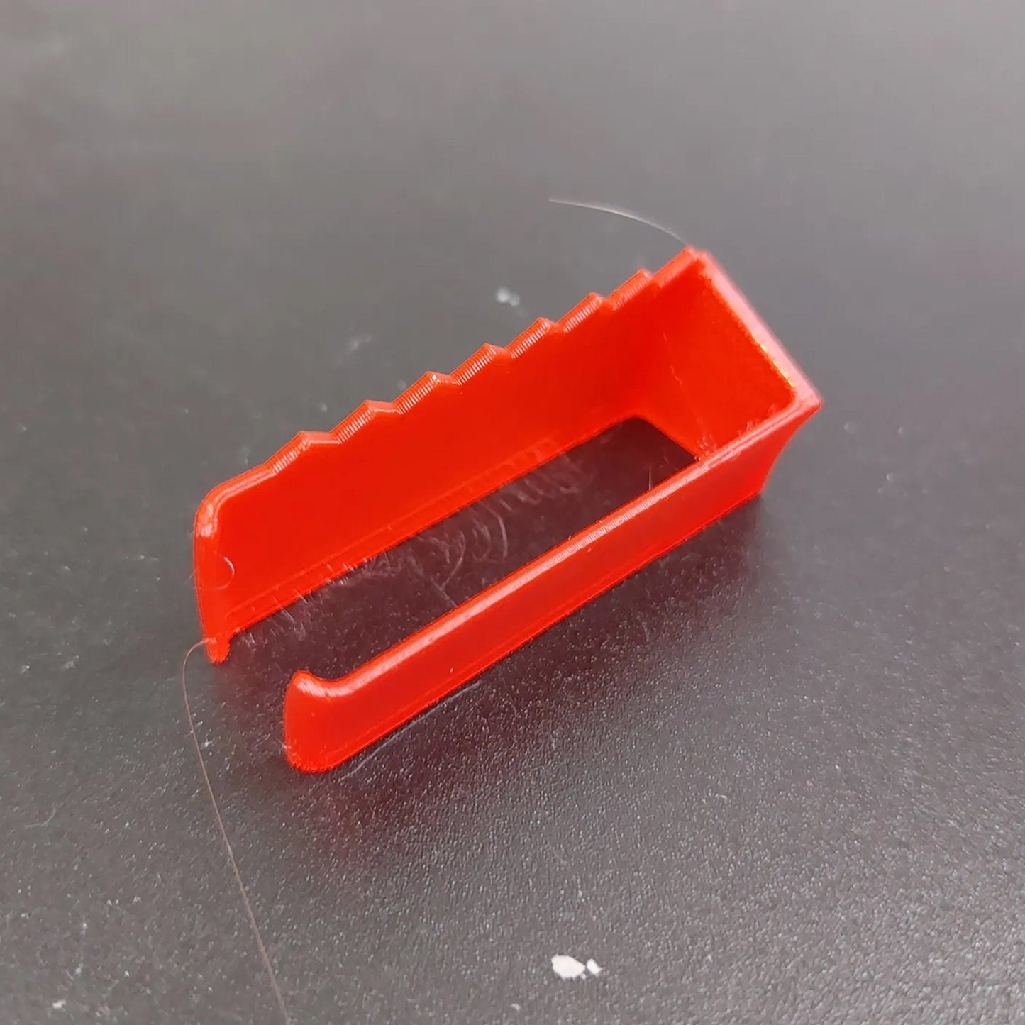 a red plastic object sitting on top of a table