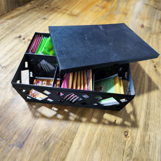 a black box filled with assorted items on top of a wooden table