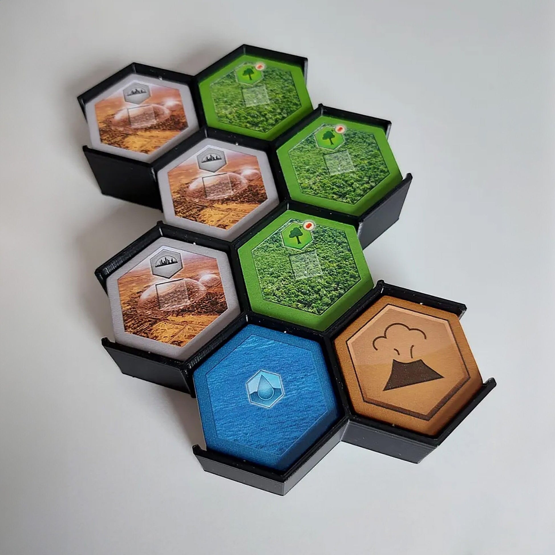 a group of four hexagonal boxes filled with different items