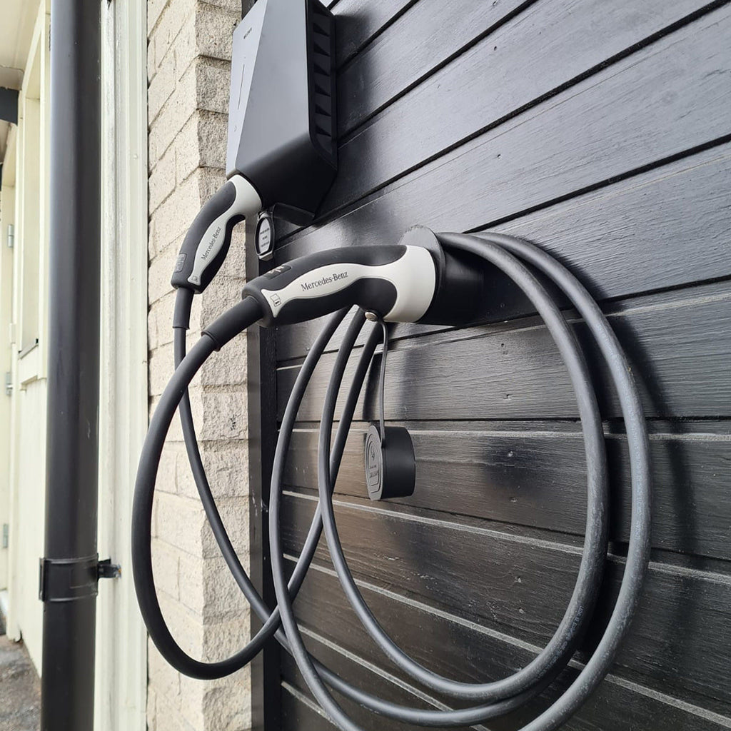 Wall mounted Type 2 EV plug holder with the charging cable looped over the top, view 3