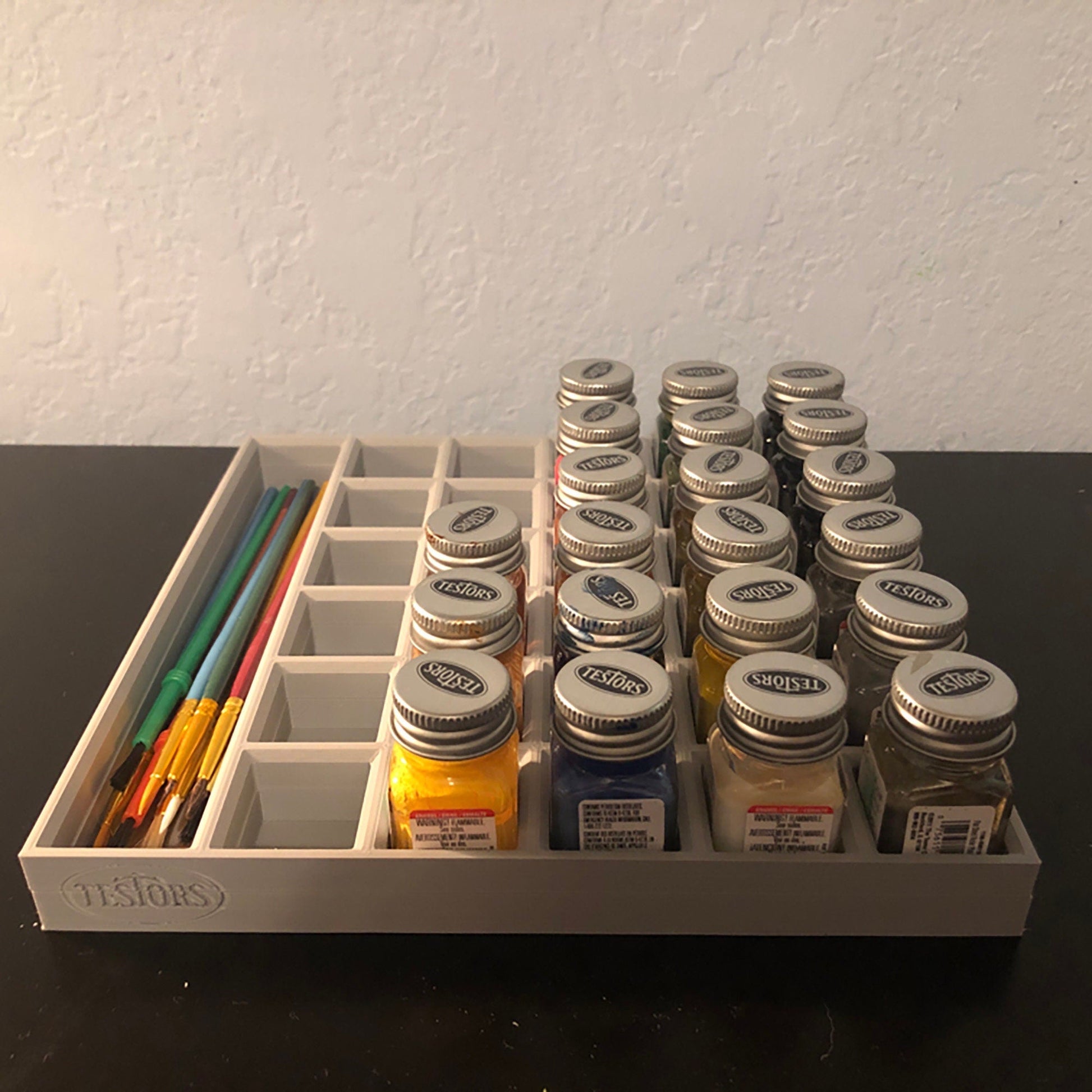 a drawer with a bunch of jars and pencils in it